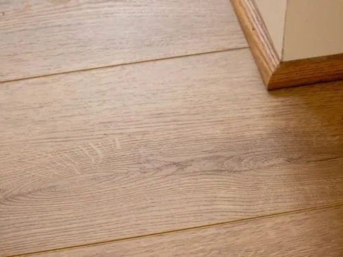 Light wood-look luxury vinyl plank flooring.