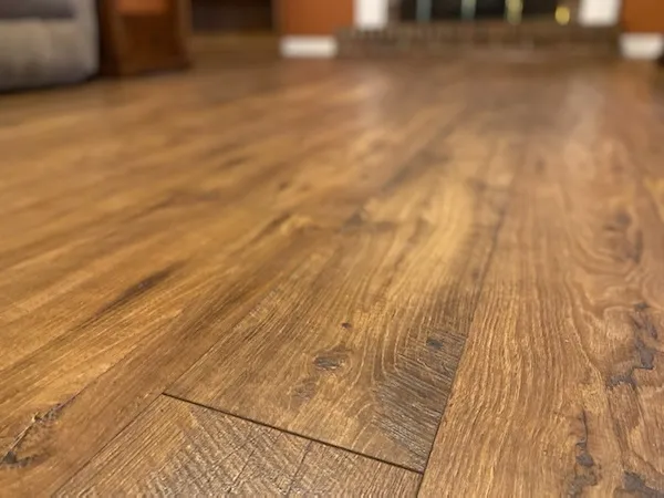 Light colored wood-look laminate flooring.