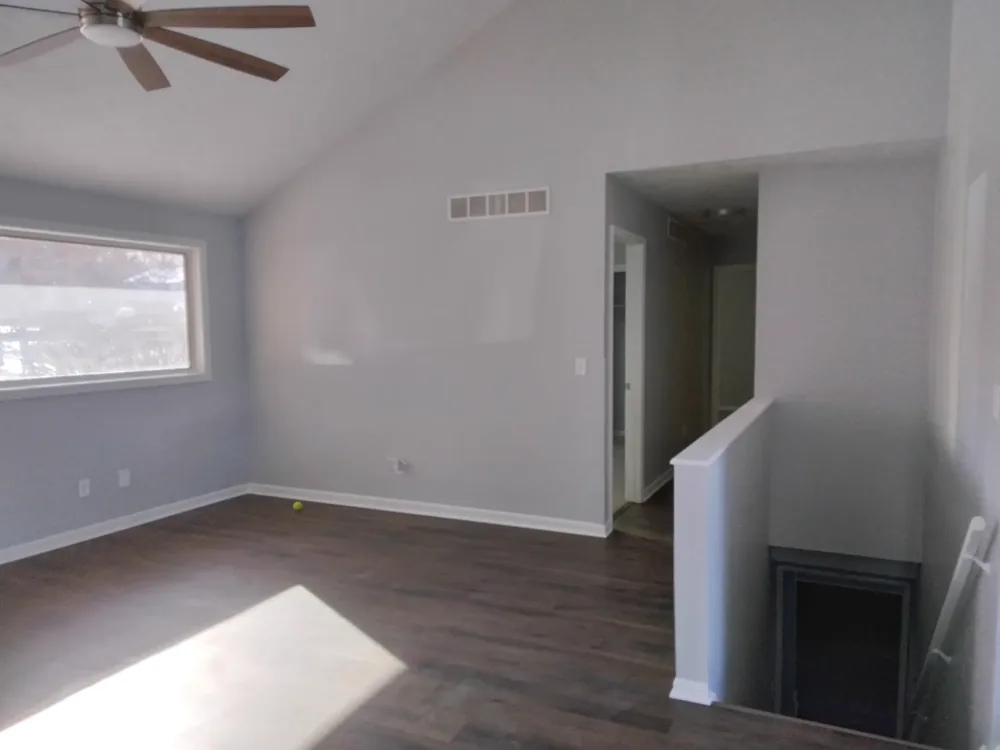 Open living room with wood-look luxury vinyl plank flooring in a Salina home