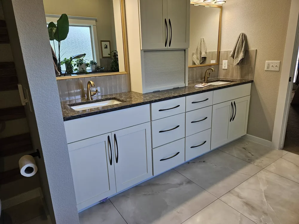 Double vanity above marble-look tile flooring in a remodeled bathroom