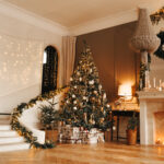 Christmas tree and staircase with hardwood flooring